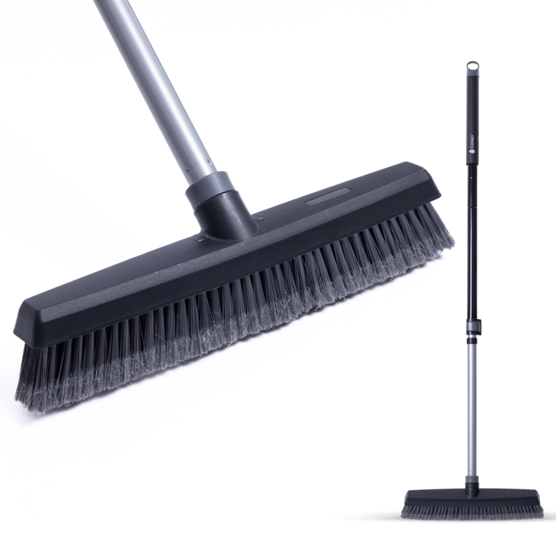 Close-up of a broom head with sturdy bristles and a telescopic handle, designed for indoor and outdoor sweeping